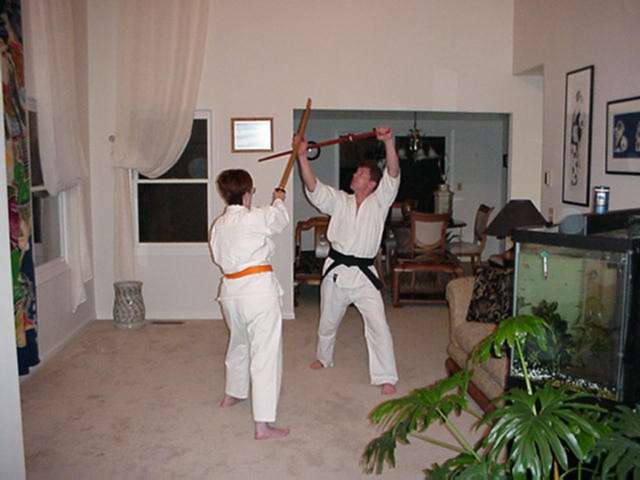 Chris Torok teaches proper Bokken technique to Maryann Cassidy